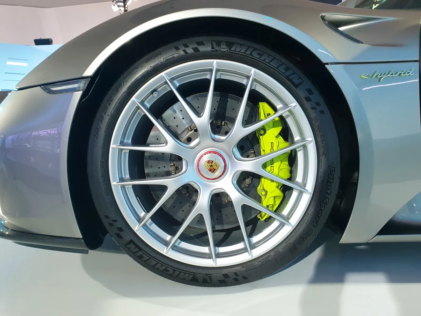 Porsche 918 Spyder front wheel and tyre in a bright showroom